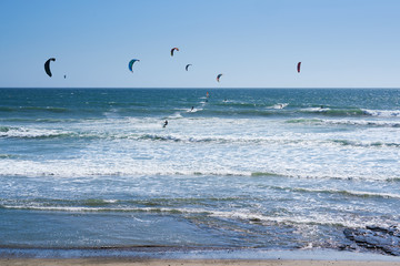 Remote view at kite surfers riding the waves in Santa Cruz, California