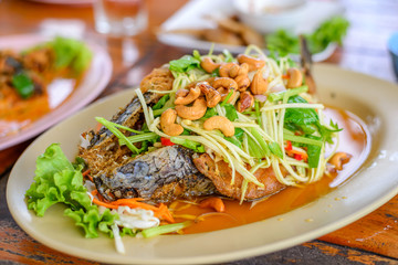 Deep fried Snake-head fish with Mixed Herb in restaurant, Thai food,  Pla Shon Lui Suan.