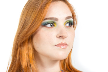 Naklejka premium Woman looks sideways, profile. Redheaded girl wearing colorful yellow dress. Summer..