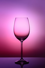 Empty glass for red or white wine on gradient background