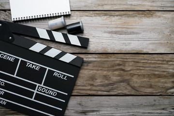 movie clapper on wood table ; film, cinema and vedio photography concept