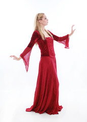 beautiful lady with long blonde hair wearing a red medieval fantasy gown. standing, isolated on white background.