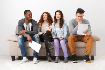 Fototapeta premium Diverse young students preparing for exam at home