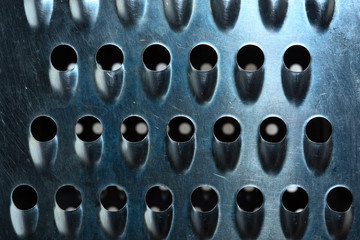 The surface of grater for vegetables and cheese is close