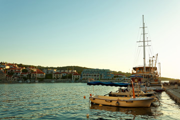 Fototapeta na wymiar Boats and fishing trawler moored in the harbor of a small town Postira - Croatia, island Brac