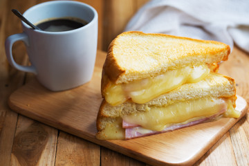 ham cheese sandwich for breakfast on wooden board