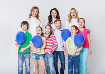 Happy kids and adults standing at white background, copy space