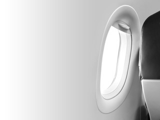 Gray aircraft window and backside of the passenger seat with black leather cover in the cabin crew, one airplane chair beside windowpane frame white background and blank space template