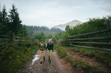 Fototapeta premium incredibly beautiful and young couple walking in the mountains
