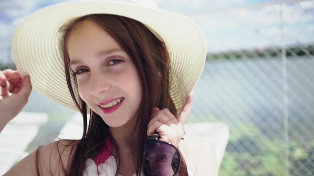 Young preteen girl in summer hat
