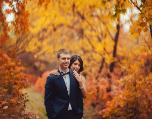Wedding couple on a walk in the autumn park