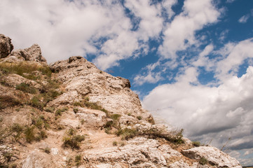 Rock on sky background with clouds. mountain background