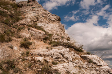 Rock on sky background with clouds. mountain background