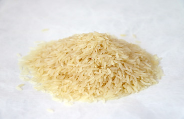 Pile of raw rice isolate on white background. rice is a swamp grass that is widely cultivated as a source of food, especially in Asia.