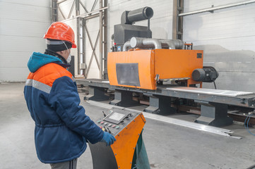 The worker works on the machine