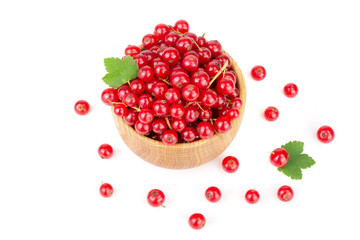 Red currant berries in a wooden bowl with leaf isolated on white background
