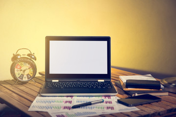 Laptop computer with desk lamp and office equipment.