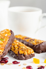 granola bars with dried fruits and honey in chocolate