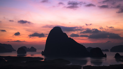 Island in the middle of the sea and colorful sunrise at Sa Met Nang She viewpoint in Phang Nga bay, Thailand