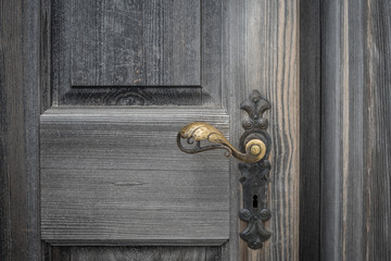 The old wooden door with doorhandle and keyhole