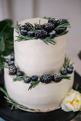 beautiful decorate wedding cake with candles and flowers