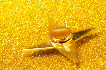 Golden spinner on a sparkling background