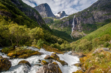 Fototapeta na wymiar Waterfall and a river in the briksdalbreen in Norway.