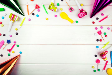 birthday party items and decorations on white wood background. top view