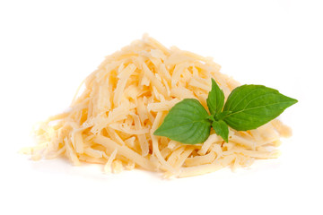 Heap of grated cheese with basil leaves isolated on white background