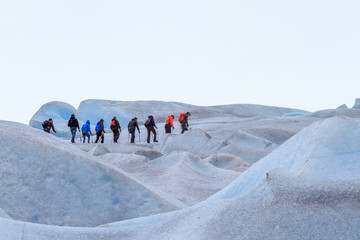 Climbers in a bunch climb the glacier