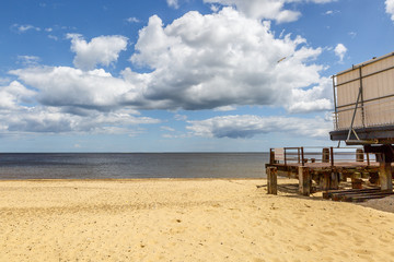 View of a wooden pier on a beautiful beach on a sunny summer day