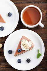 Cheesecake with blueberries on a wooden background