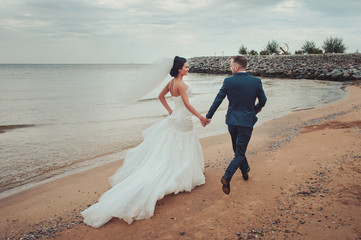 Beautiful bride and groom couple walking at the wedding
