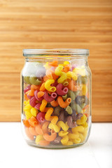 Multicolored Italian pasta in a jar