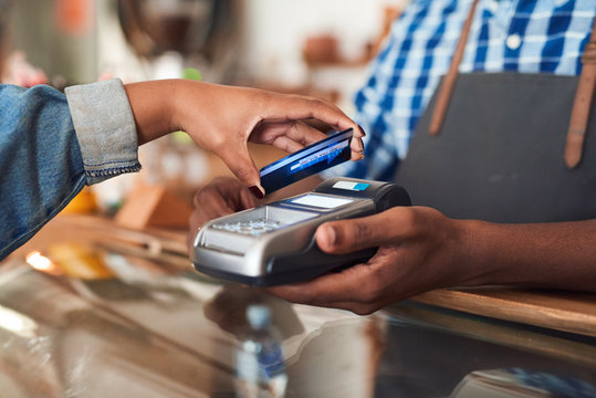 Customer Paying For Her Cafe Purchace With Nfc Technology