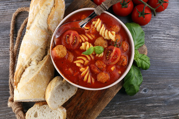 Tomato soup with meatballs in a bowl. Italian minestrone soup