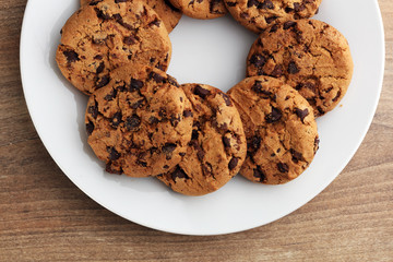 Chocolate cookies on wooden table. Chocolate chip cookies shot
