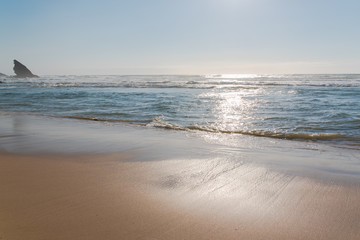 Portugal, beach, beautiful seascape in the evening, sunset with sea spray
