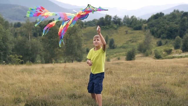The boy runs and launches a snake in the mountains