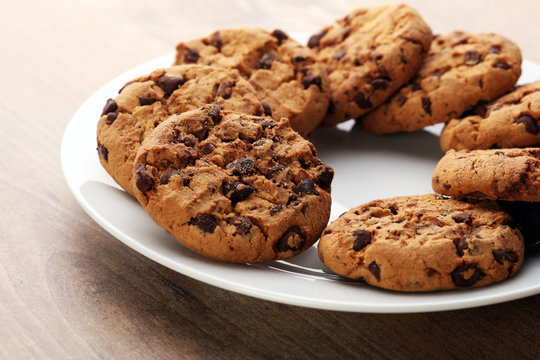 Chocolate cookies on wooden table. Chocolate chip cookies shot