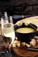 Gourmet Swiss fondue dinner on a winter evening with assorted ch
