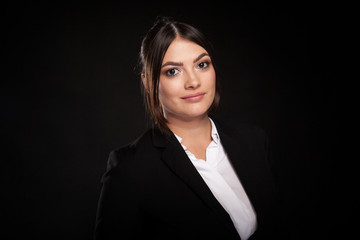 Portrait of beautiful successful businesswoman in studio photo over black background