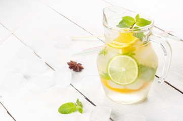 Jug with Lime and Orange Fruit Water with ice