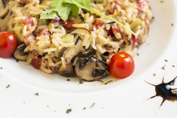 Fragrant Pilau/Pulav / pilaf /pilaf, fried rice with meat and vegetables on a white plate. Isolated on a wooden table.