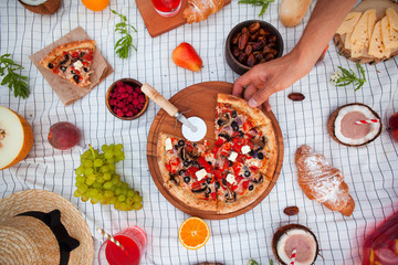 Picnic on the beach at sunset in the white plaid, food and drink conception