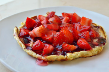 Closeup of Pancake with strawberries on a marble countertop