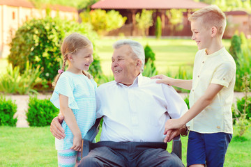 Fototapeta premium Portrait of happy old grandfather and cute children