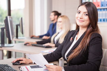 Fototapeta premium Business person working in office next to colleagues