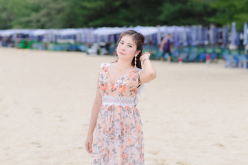  Portrait Beautiful woman thailand posing on the beach with light rain