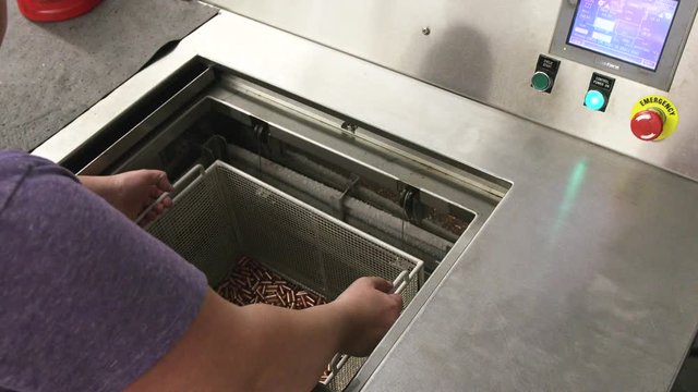 Worker places shells of bullets into machine
